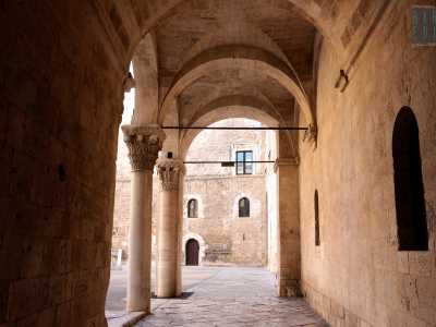 Alla fine dell�androne si sviluppa l�affascinante portico angolare di accesso al cortile, terminante in archi a tutto sesto che si intrecciano in volte a crociera